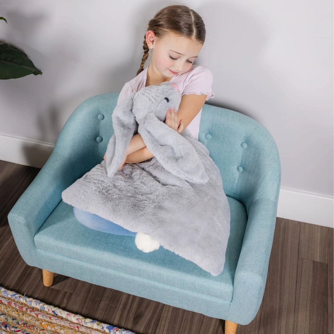 Girl hugging weighted lap bunny, autism sensory toy, calming plush for ADHD, stress relief stuffed animal, gray therapeutic bunny lap pad for kids anxiety and sensory processing support.